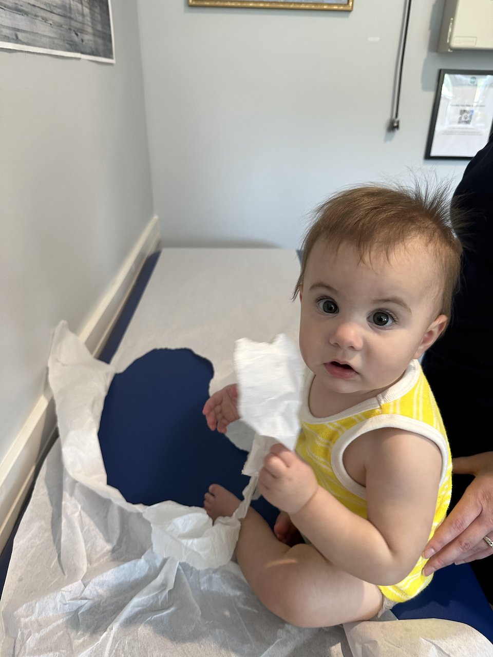 Zoe looking a touch concerned with just how bad she ripped the table paper at the pediatricians.